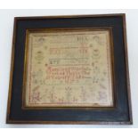 A Victorian needlework sampler decorated with the alphabet letter, numbers, numbers and the text Ann