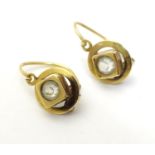 A pair of 19th gold earrings set with central paste stones. (unmarked tests as 18ct gold) approx 1/"