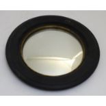 A 19thC convex mirror with an ebonised surround and giltwood lining. 16" in diameter. Please