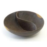 A treen wooden two sectional bowl with central division. Approx. 2 1/2" high x 8" diameter. Please