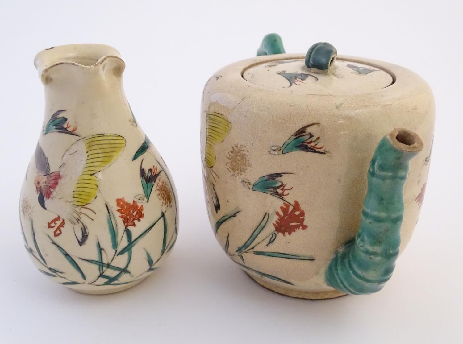 A Japanese teapot and milk jug with hand painted decoration depicting birds and flowers, the handles - Image 4 of 9