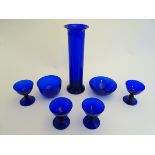 7 assorted items of blue glass comprising drinking glasses, dish, vase etc. The tallest 12 3/4''