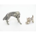 A white metal pendant formed as a kitten playing with a ball of wool together with a cast model of a