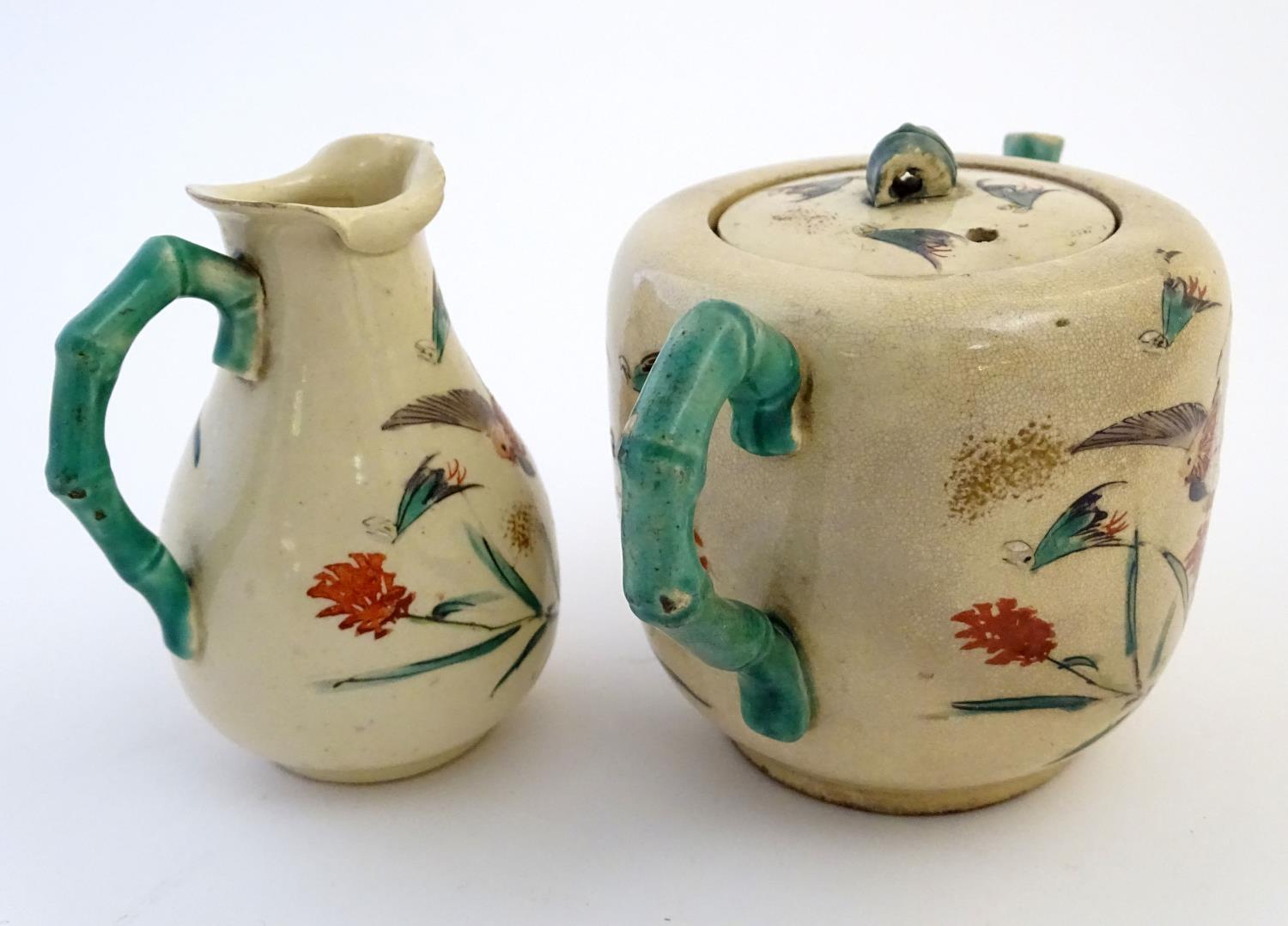 A Japanese teapot and milk jug with hand painted decoration depicting birds and flowers, the handles - Image 5 of 9