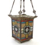 A late Victorian pendant lantern with stained glass panels and reticulated brass frame and