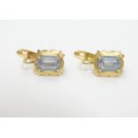 A pair of gold earrings set with pale blue paste stones. Approx 1/" long Please Note - we do not