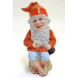 A 20thC Continental terracotta gnome modelled as a seated fisherman. Approx. 10" high Please