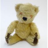 Toy: A mohair teddy bear with articulated limbs, pad paws, stitched claws, and a proud, stitched