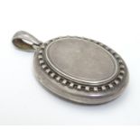 A silver pendant of locket form 2" long Please Note - we do not make reference to the condition of