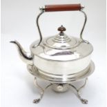 A silver plate spirit kettle and stand with burner under, maker Hukin & Heath. 10" high Please