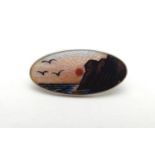 Scandinavian jewellery : A silver brooch of oval form decorated with guilloche enamel sunset