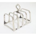 A silver four slice toast rack, hallmarked Birmingham 1933, maker Adie Bros Ltd. 3" long Please Note