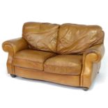 A late 20thC Italian tan leather two-seat sofa, 67" wide, 31" deep, 40" tall Please Note - we do not