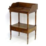 A mid 19thC mahogany washstand with a shaped upstand above four turned legs united by an under