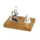 A Continental .925 silver miniature model of a microscope etc. mounted on a wooden base. Approx.
