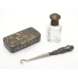 Three items comprising a small button hook with white metal handle a small glass bottle and a