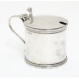 A silver mustard pot with blue glass liner, hallmarked Birmingham 1920 maker J B Chatterley & Sons