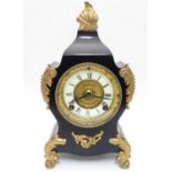 An early 20thC Ansonia mantel clock, of plate metal construction with blacked and gilt finish, the