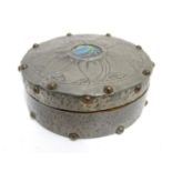 An Arts and Crafts turned wooden lidded pot of circular form with pewter covering and stud detail,