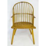 A late 18thC Windsor chair with a double bowed back and splayed arms above a shaped elm seat and