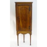 An 18thC and later fruitwood corner cupboard with a moulded cornice and moulded frieze above a