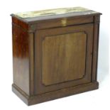 A Regency mahogany cupboard with applied roundel decorations and having a single panelled door above