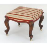 A 19thC mahogany stool with an upholstered top above carved cabriole legs, scrolled feet and