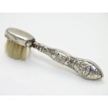 A silver handled moustache brush with embossed detail. Hallmarked Birmingham 1903 maker Adie Lovekin
