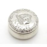 A small silver pot of circular form with embossed angel decoration hallmarked Birmingham 1902