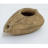 A Roman style terracotta oil lamp with incised decoration. Approx. 1 1/2" high Please Note - we do