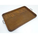 An Edwardian oak tray, with moulded edge and white metal handles, 22 3/4" long, 15 3/4" wide