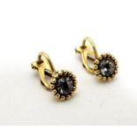 A pair of gilt metal clip earrings set with white stones Please Note - we do not make reference to