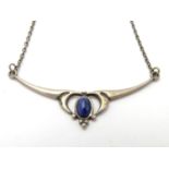 A silver necklace set with blue stone cabochon in the Art Nouveau style Approx 16" long Please