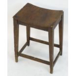 An 18thC elm stool with a bowed top above squared tapering legs and united by a box stretcher. 14?