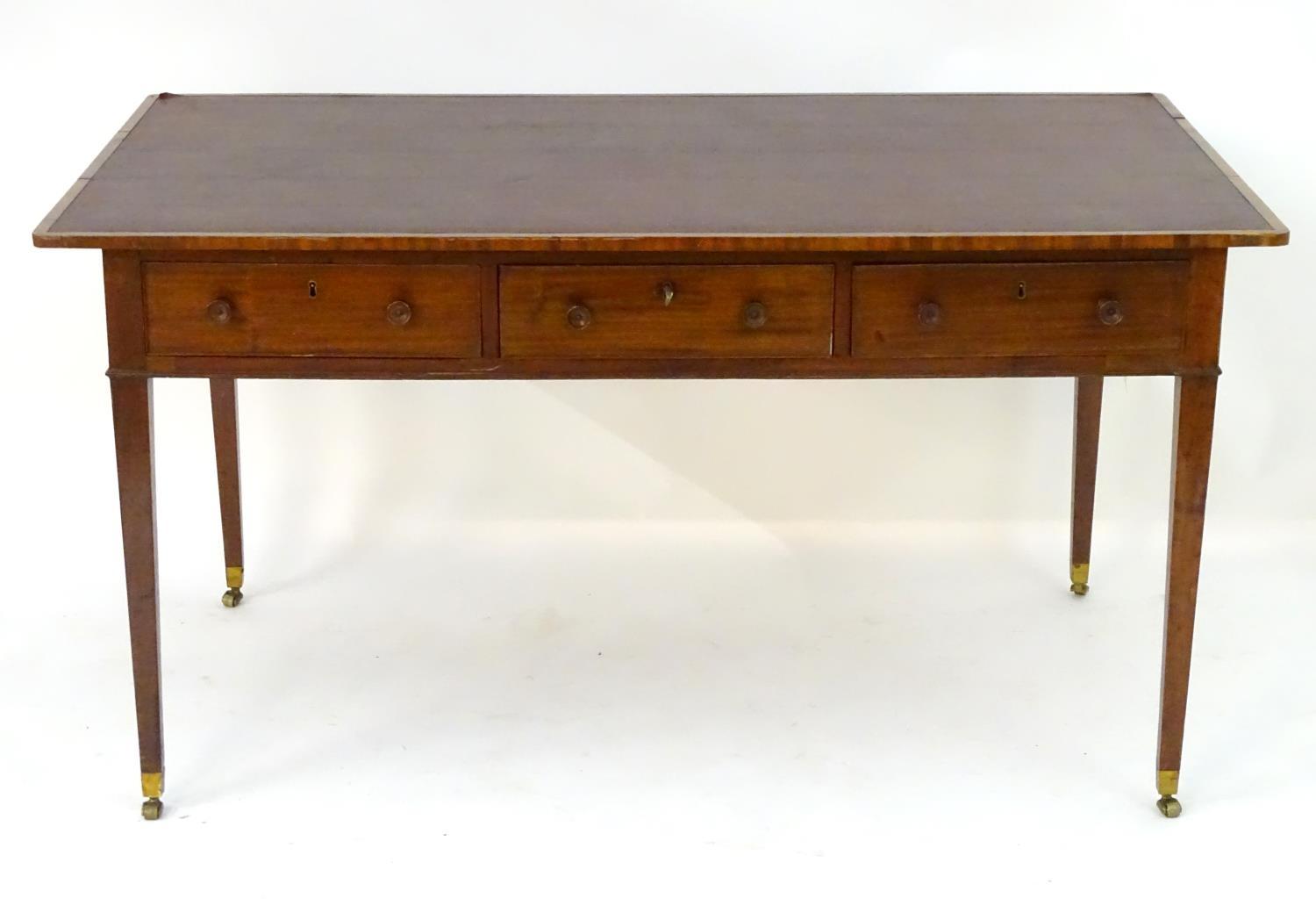A late 18thC / early 19thC mahogany writing table with an inset top above three short drawers and - Image 4 of 7