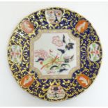 A Mason's plate with lobed rim decorated with chinoiserie style detail and ornate gilt border.