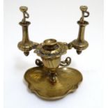 A late 19th / early 20thC cast and gilded table cigar lighter, the base formed as a stylised lily