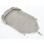 A ladies white metal purse with chain mesh body. Approx 4 1/" long Please Note - we do not make