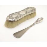An Art Nouveau silver mounted clothes brush with peacock decoration, hallmarked Birmingham 1901