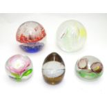 Five art glass paperweights, including an example by Caithness, Scotland formed as a snow capped