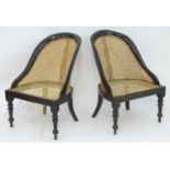 A pair of 19thC low bergere chairs with caned seats and backrest, the chairs raised on turned