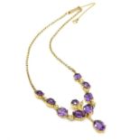 A 9ct gold drop necklace set with seed pearls and a profusion of amethyst. Approx 15" long Please