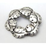 A Danish silver brooch of circular form with leaf detail. By Niel Erik From of Denmark 1 1/2" long