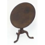 A late 19thC mahogany small proportion tilt top table with a turned pedestal base and three cabriole