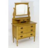 A late 19thC / early 20thC walnut dressing table, having a moulded cornice above an arched