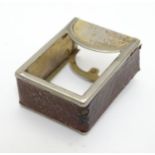 A miniature deck of playing cards contained within a silver plate and leather case. Approx 1 3/4"