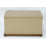 A Victorian upholstered ottoman with an overstuffed seat / lid opening to show storage space within,