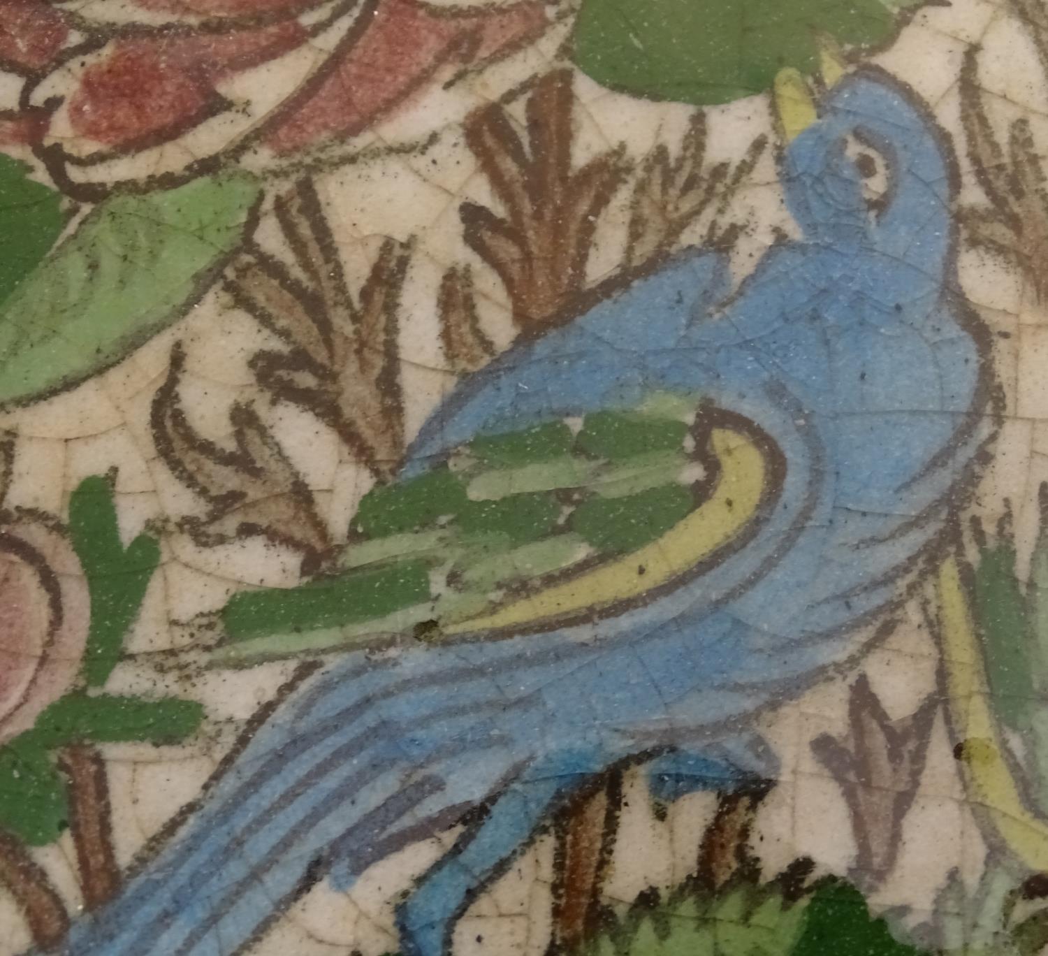 A Persian tile of square form decorated with stylised birds, flowers and foliage within a blue - Image 3 of 6