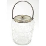A cut glass biscuit barrel with silver plated mounts . Approx. 7" high Please Note - we do not
