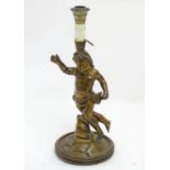 A 20thC Italian carved wooden lamp, formed as a putto with gilt finish and circular base, 21 1/4"